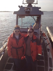 two team members standing on boat