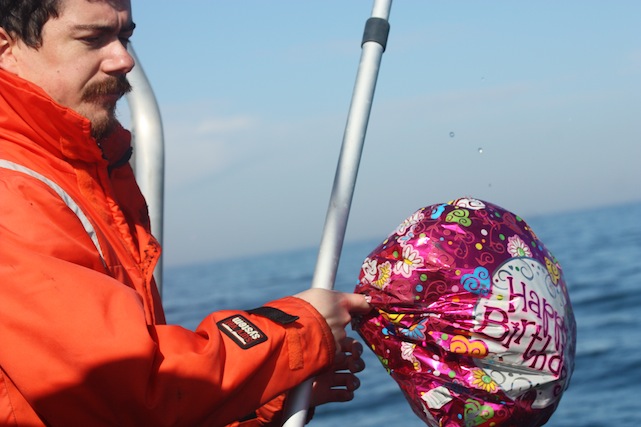 man holding deflated balloon