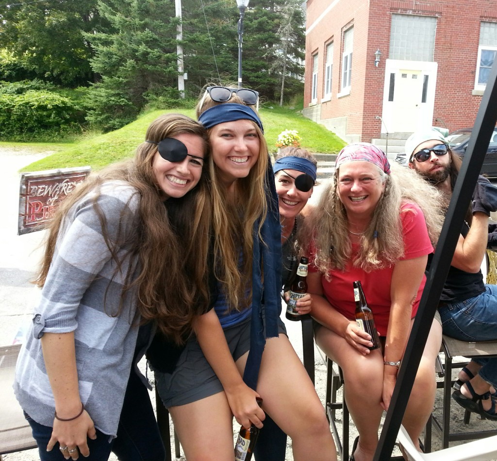 team members posing while dressed as pirates