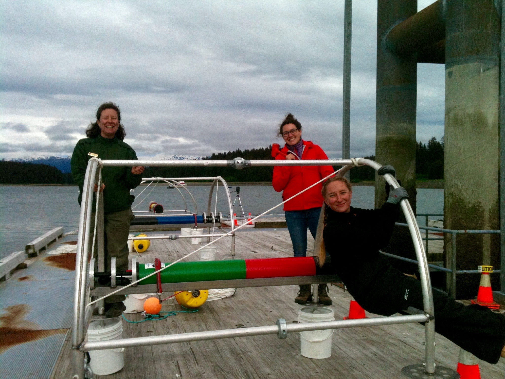 lab members posing with equipment on dock